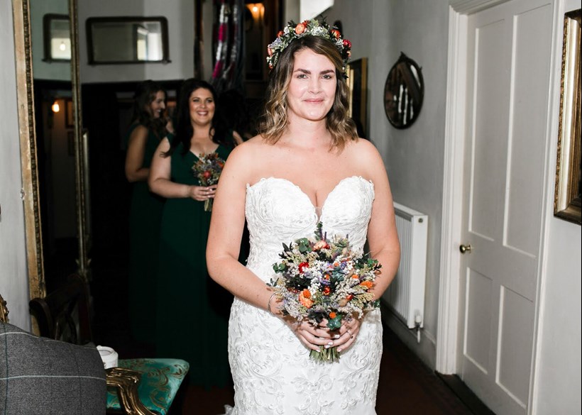 Bride in simple make up with floral headdress and bouquet at Ash Barton, Devon Wedding Venue
