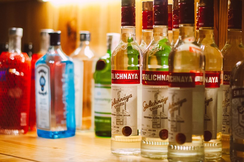 Bottles of alcohol on the bar in the big party party at Ash Barton wedding venue