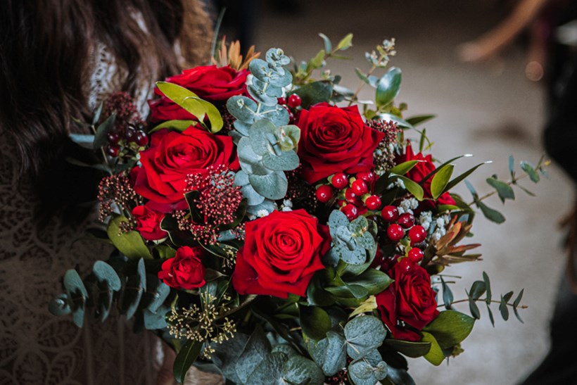Winter wedding bouquet or red roses and berries