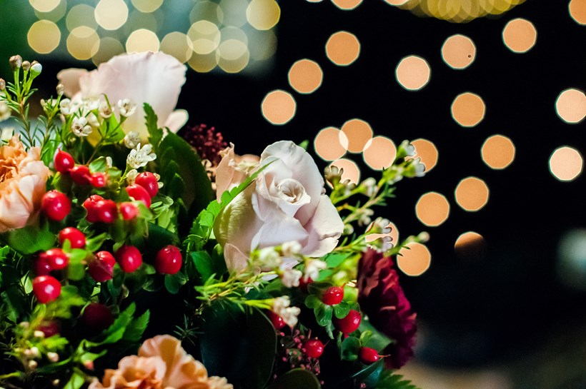 Winter wedding bouquet of white roses and red berries