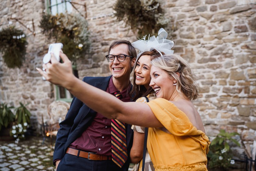 Three wedding guests take a selfie at Ash Barton wedding venue