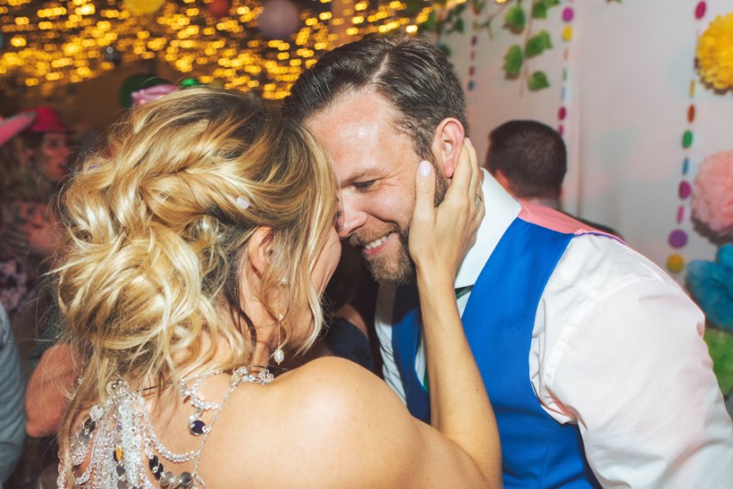 Bride and groom kiss on dance floor at Ash Barton wedding venue