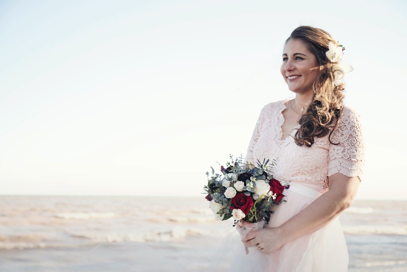 Bride on beach in wedding dress