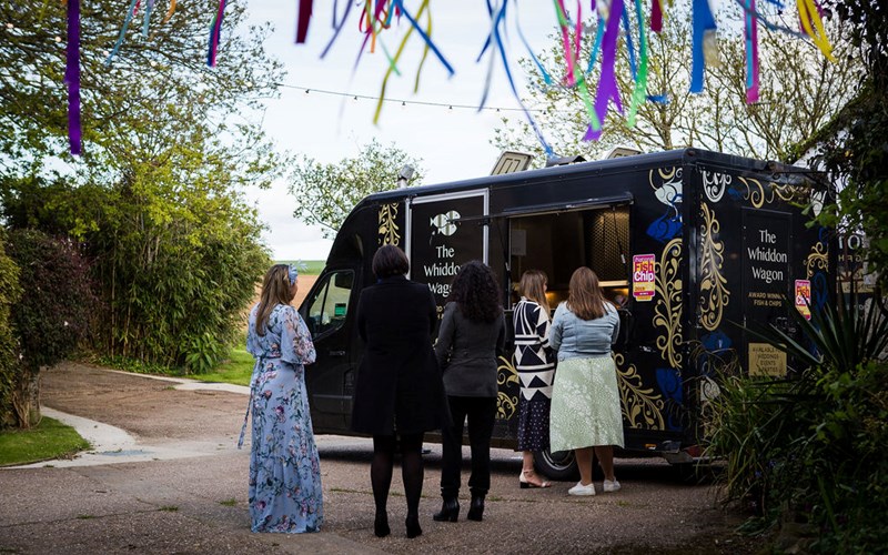 Ashbarton Estate - Wedding guests queuing for first and chips from Whiddon Wagon mobile chippy at Ash Barton Devon wedding venue 