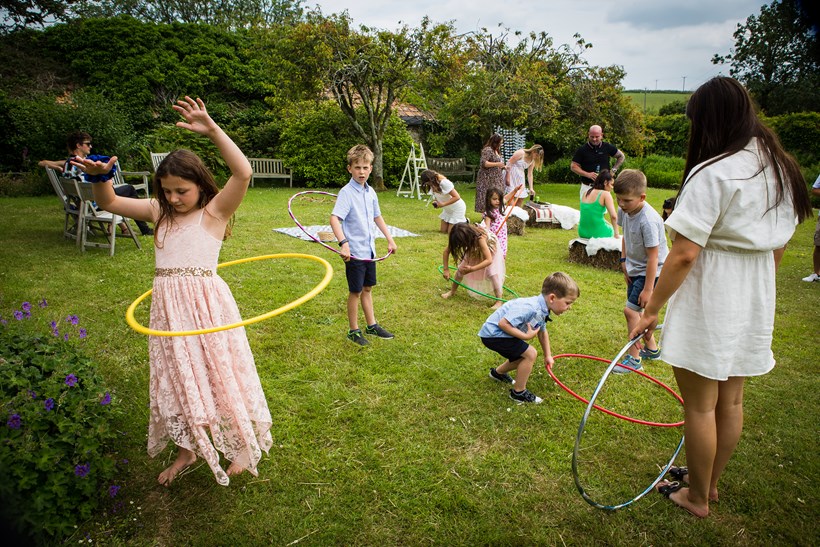Kids playing hoola hoop in walled garden at Ash Barton Devon wedding venue