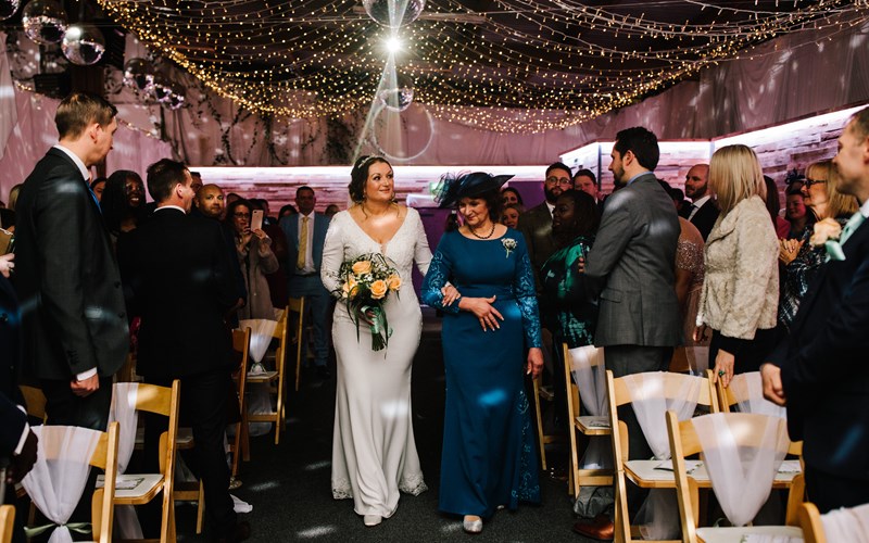 Ashbarton Estate - Bride walks down aisle in big party barn wedding venue Devon