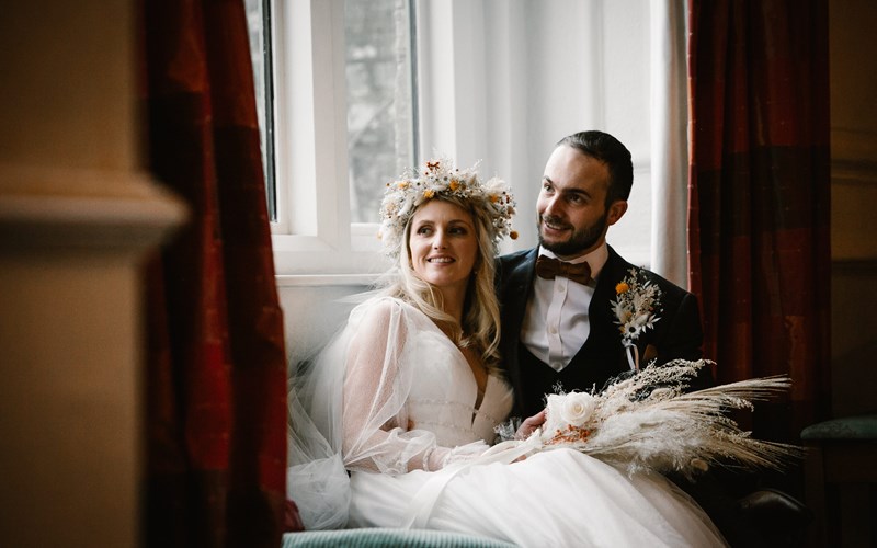 Ashbarton Estate - Bride and groom sit in window at Ash Barton wedding venue Devon 