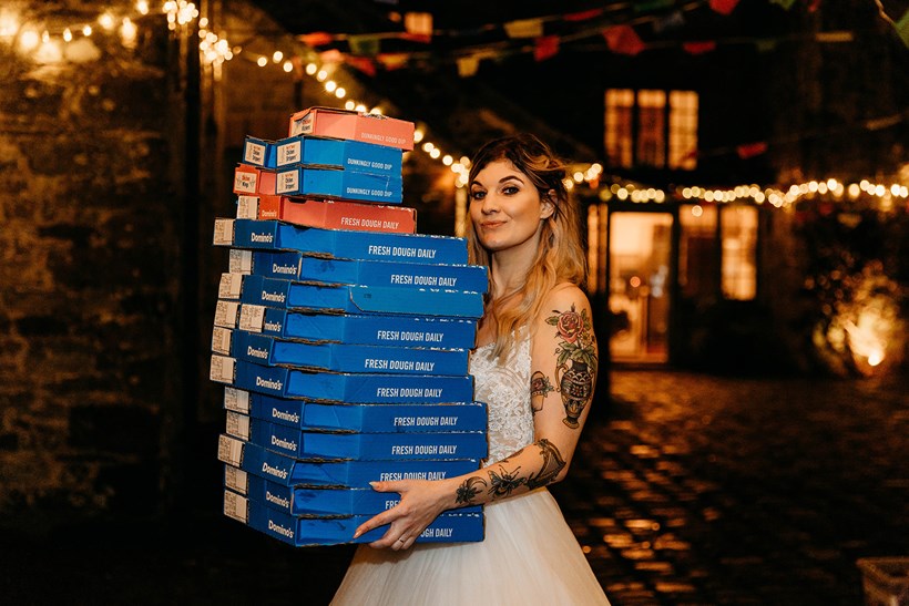 Bride holding pizza boxes at Ash Barton Wedding Venue Devon