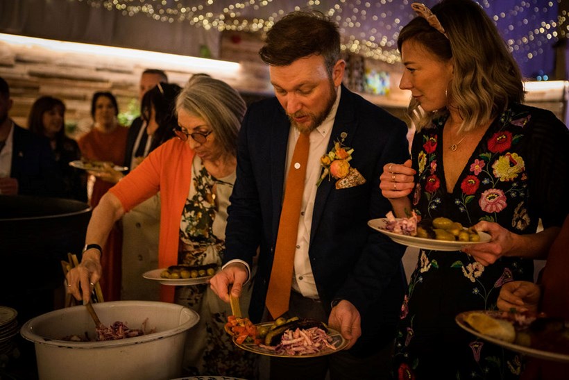 Guests filling their plates at Ash Barton wedding venue Devon