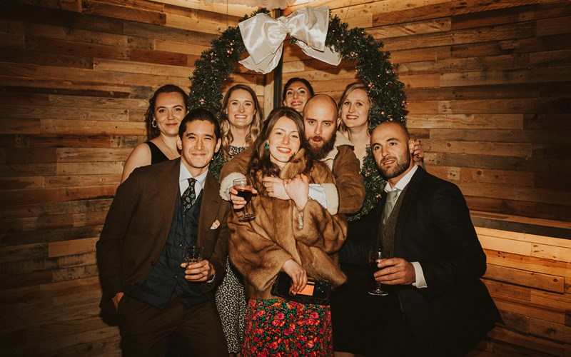 Ashbarton Estate - Wedding guests in front of wreath at Ash Barton wedding venue Devon