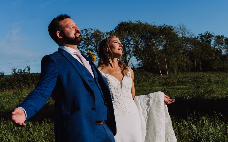 Ashbarton Estate - Bride and groom in wildflower meadow at Ash Barton wedding venue Devon