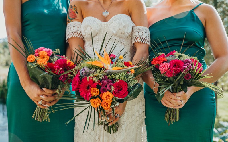 Ashbarton Estate - Bride and bridesmaids in green holding bouquets in close up at Ash Barton wedding venue Devon
